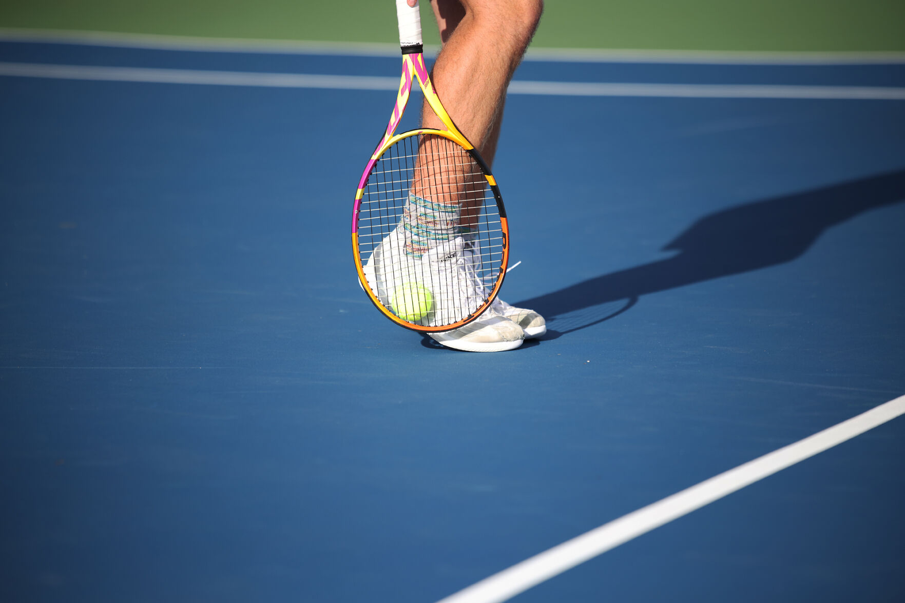 Will Forsyth picks up a tennis ball